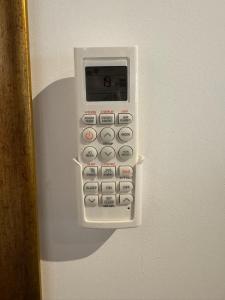 a remote control is attached to a wall at Chalé da Praia Paraty in Paraty