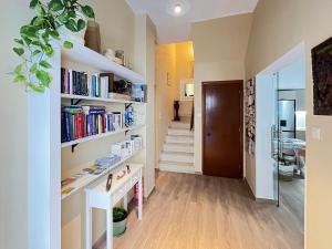 a hallway with white shelves filled with books at Pefkakia Park in Ermoupoli +69 photos