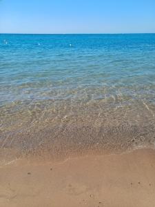 a body of water with a sandy beach at Luxury Studio Pool & Free Private Beach, Close to Airport in Hurghada