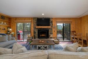 a living room with a couch and a fireplace at 1126 Western Road in Grand Lake