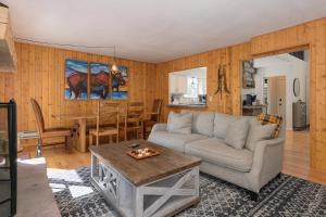 a living room with a couch and a table at 1126 Western Road in Grand Lake