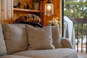 a couch with pillows in a room with a window at 1126 Western Road in Grand Lake +31 photos