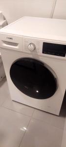 a white microwave oven sitting on top of a counter at Santiago Apartment in Caminha