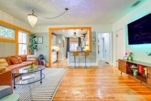 a living room with a couch and a tv at Midtown Oasis - BBQ, Deck, Games & Artistic Vibes in Sacramento