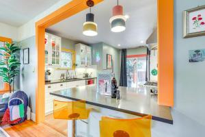 a kitchen with a large counter in the middle at Midtown Oasis - BBQ, Deck, Games & Artistic Vibes in Sacramento