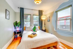 a bedroom with a bed and a window at Midtown Oasis - BBQ, Deck, Games & Artistic Vibes in Sacramento