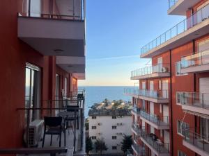 a view of the ocean from the balcony of a building at BlueWaveapartments 4 in Shëngjin