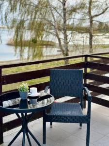 a blue chair and a table with a cup on it at Prenoćište Šoderica in Legrad