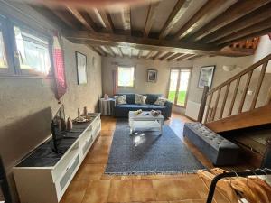 a living room with a couch and a table at Gîte des sabotiers in Le Boissenet