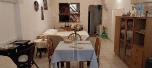 a living room with a table with a vase of flowers on it at LA CASETTA in puglia in Montalbano