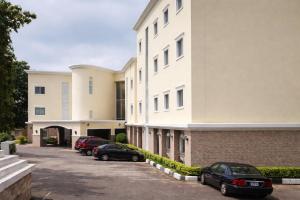 a row of cars parked in front of a building at The Savannah Hotel, Garki in Abuja