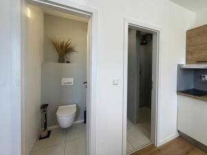 a bathroom with a toilet and a sink at Apartmán Zamarovce in Trenčín