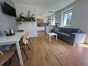 a living room with a couch and a table at Apartmán Zamarovce in Trenčín