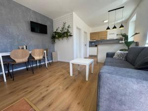 a living room with a couch and a table at Apartmán Zamarovce in Trenčín +7 photos