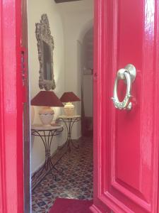 a red door in a room with two tables at Apartment best Harbour view in Valletta