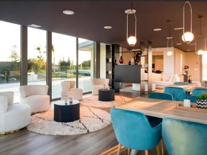 a lobby with a table and chairs and a large window at Eden50 in Mijas Costa