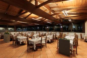 a banquet hall with white tables and chairs at Albergo Baffo in Chiuro +39 photos