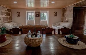 a living room with a table with bottles on it at Casa dos Muiños in Pontevedra