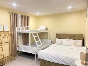 a room with two beds and a room with two bunk beds at Casa de Matilda in Silang