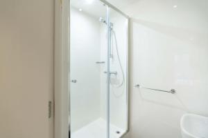 a shower with a glass door in a bathroom at Stylish & Spacious Studio - Prime Briggate Location -Walk Everywhere in Leeds