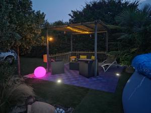 a backyard with a gazebo at night at Le Maillotin en balade in Les Maillys