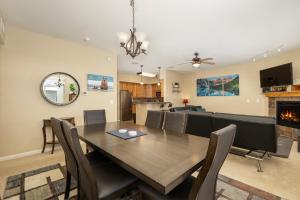 a dining room and living room with a table and chairs at 175 Spinner 5-2 in Fraser