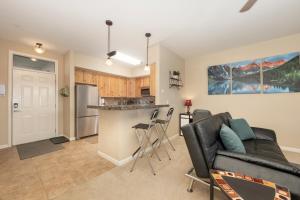 a living room with a couch and a kitchen at 175 Spinner 5-2 in Fraser +13 photos