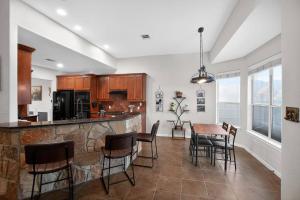 a kitchen and dining room with a table and chairs at Spacious 4BR Retreat |Pool Table| Firepit & Hottub in Kyle