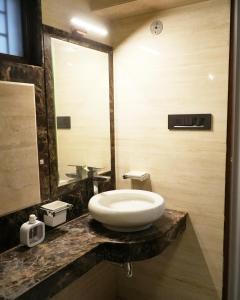 a bathroom with a white sink on a counter at Autumn House in Jaipur +29 photos