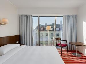 a hotel room with a bed and a large window at Park Inn by Radisson Meriton Conference & Spa Hotel Tallinn in Tallinn