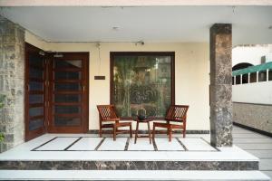 two chairs and a table in front of a door at Autumn House in Jaipur