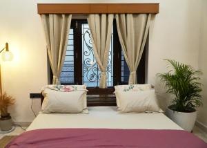 a bedroom with a large bed with a window at Autumn House in Jaipur