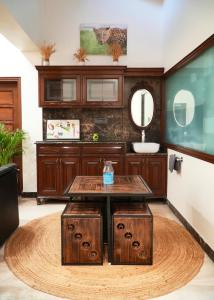 a bathroom with a wooden table and a sink at Autumn House in Jaipur