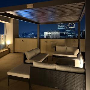 a balcony with a view of a city at night at Caelum Black Gangnam Luxury Residence in Seoul