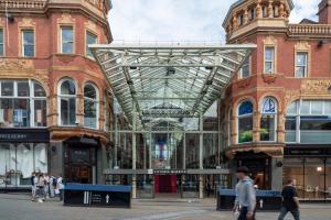 a shopping centre in a city with people walking around at Stylish & Spacious Studio - Prime Briggate Location -Walk Everywhere in Leeds