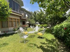 a group of chairs sitting in the grass at Pacific Guest House Skardu in Skardu