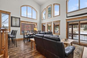 a living room with leather furniture and windows at 21 GCR 4435 in Grand Lake