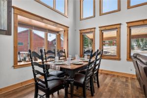 a dining room with a table and chairs and windows at 21 GCR 4435 in Grand Lake