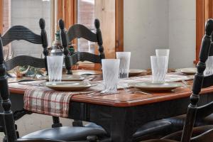 a wooden table with plates and glasses on it at 21 GCR 4435 in Grand Lake