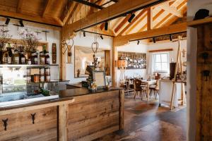 a tasting room with a bar and a dining area at Auerhiasbauer in St. Wolfgang