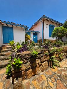 a stone retaining wall in front of a house at Casa Raisol Barichara in Barichara