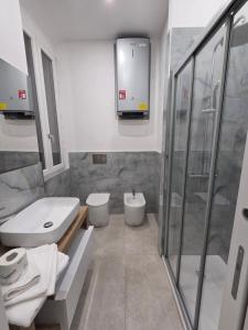 a bathroom with a toilet and a sink and a shower at Dimore Marche Porto Recanati in Porto Recanati
