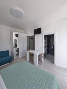 a living room with a table and a blue couch at Dimore Marche Porto Recanati in Porto Recanati