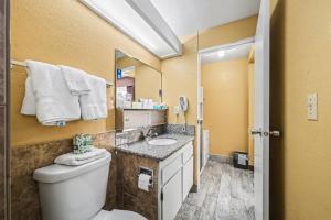 a bathroom with a toilet and a sink at Travelodge by Wyndham Kanab in Kanab +48 photos