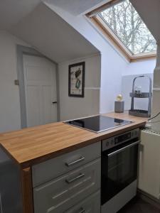 a kitchen with a sink and a stove at Ferienwohnung Zeit für Meer in Kruså +14 photos