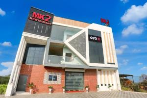 a man standing on top of a building at Hotel O MK2 Hotel and Restaurant in Indore