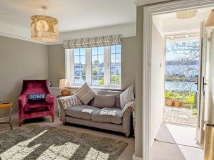 a living room with a couch and a chair at Thimble Cottage - Emsworth in Emsworth