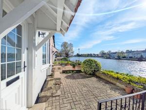 a house with a balcony with a view of the water at Thimble Cottage - Emsworth in Emsworth