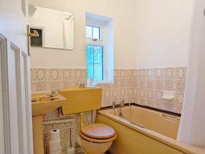 a bathroom with a toilet and a sink and a tub at Thimble Cottage - Emsworth in Emsworth