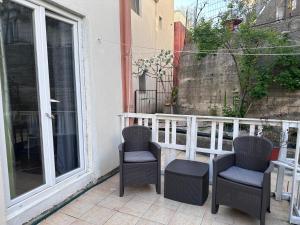a couple of chairs sitting on a balcony at Green Villa in Šušanj +85 photos